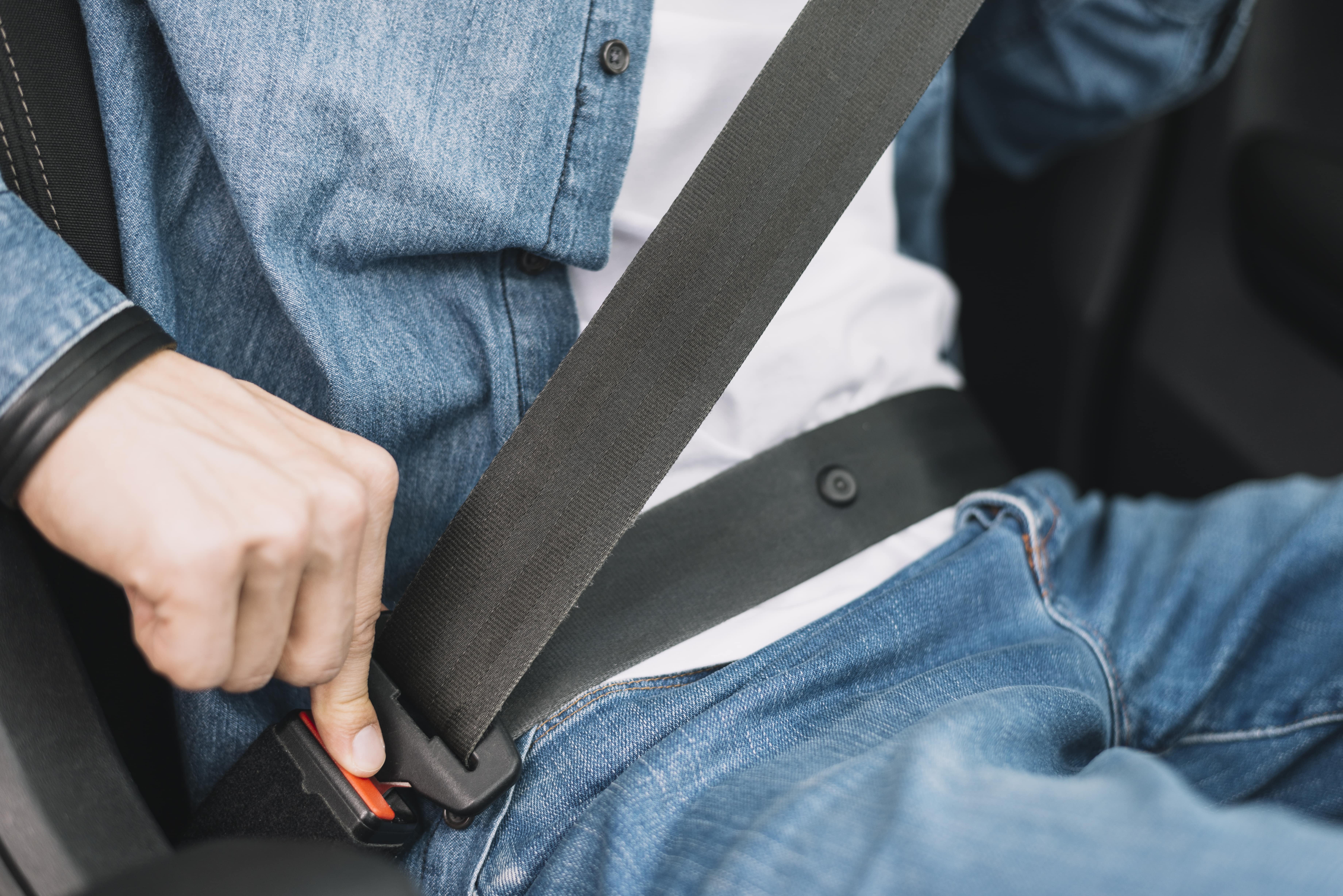 close up man putting safety belt min