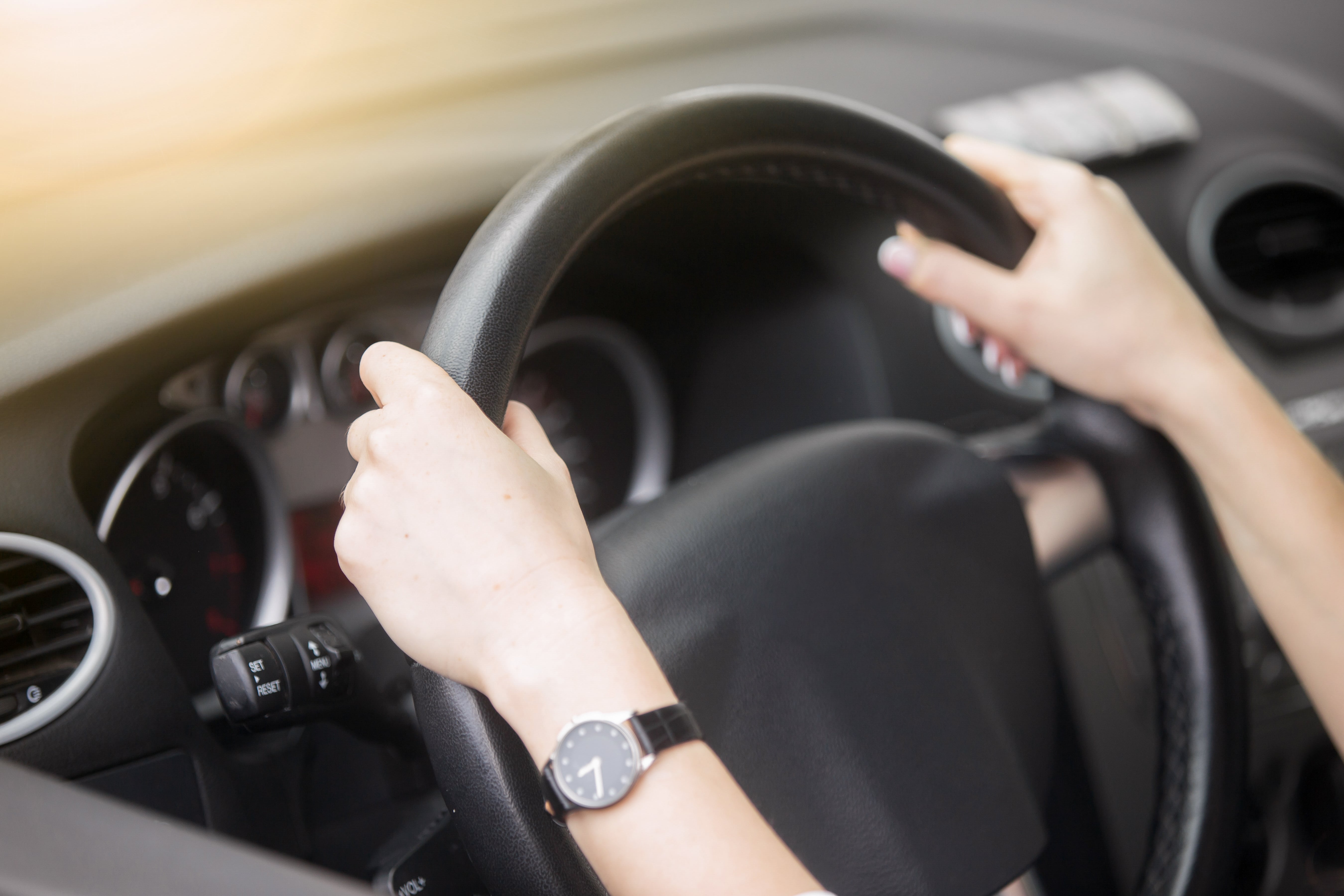 portrait attractive smiling woman driving car min